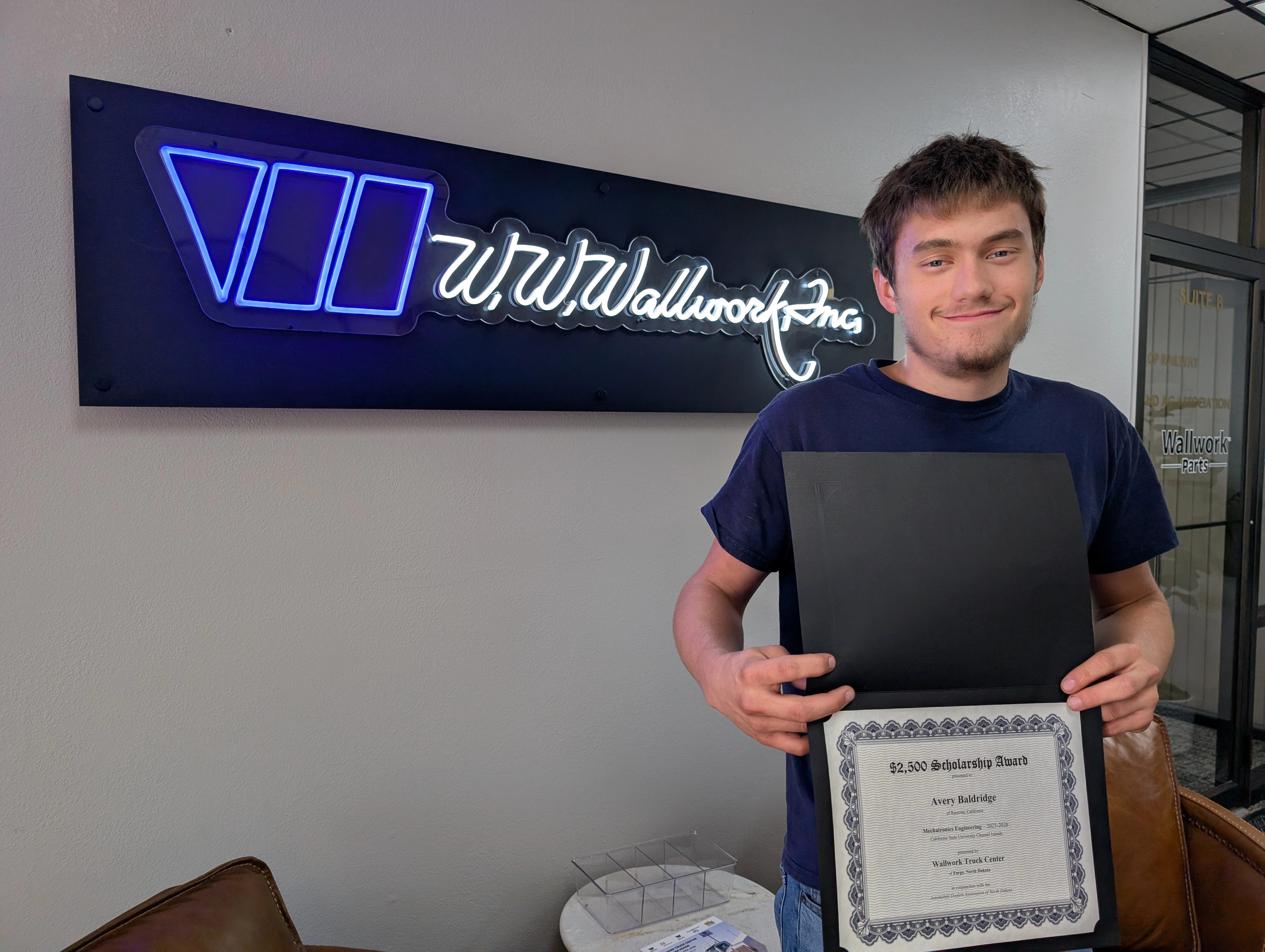 Avery Baldridge showing his ADAND scholarship