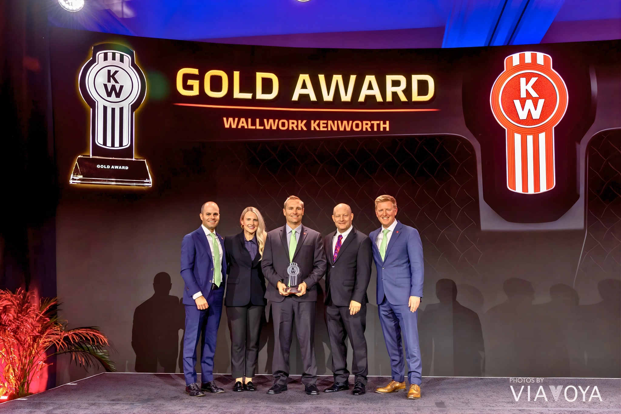 Reople from Wallwork Kenworth are standing with 2025 Kenworth Gold Award for Operational Excellence